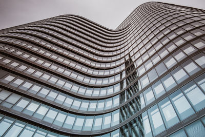 Low angle view of modern skyscraper against sky