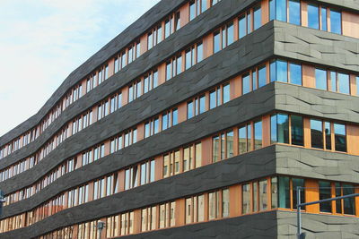 Low angle view of office building against sky