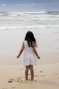 Rear view of girl on beach