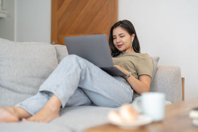 Young woman using laptop at home