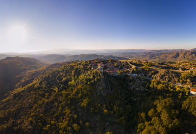 Drone aerial panorama of historic village of sortelha with castle and with turbines