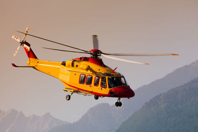 Low angle view of helicopter flying against clear sky