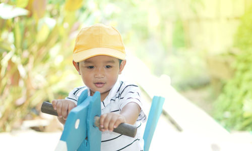 Cute boy sitting on rocking horse