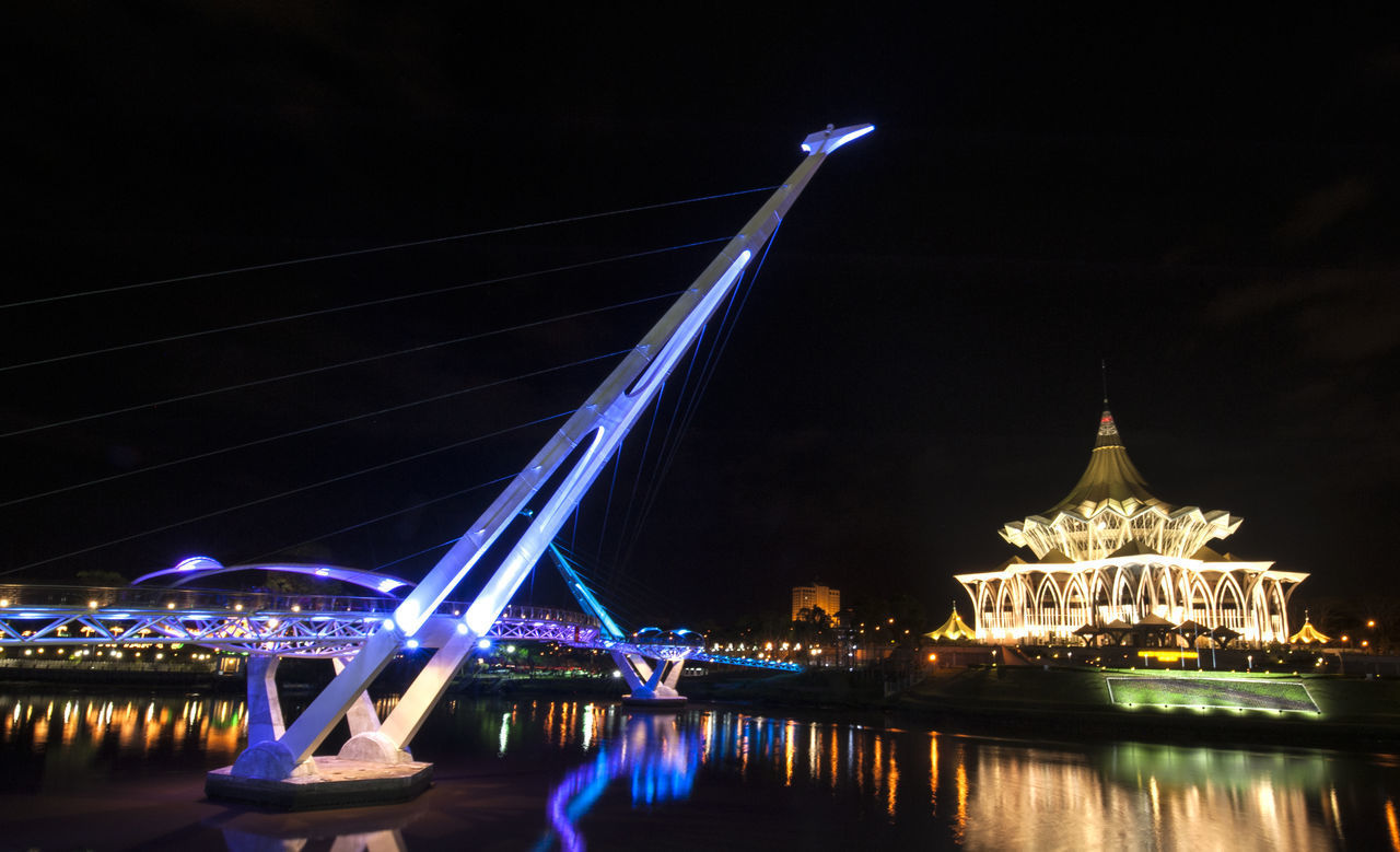 VIEW OF BRIDGE OVER RIVER AT NIGHT