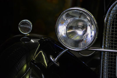 Close-up of vintage car against black background