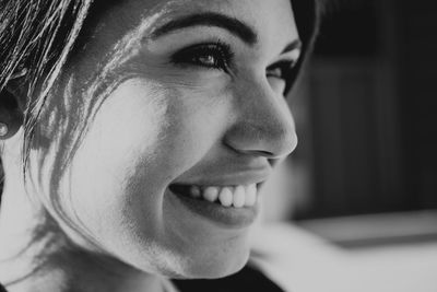 Close-up of smiling young woman looking away