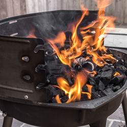 Close-up of coal burning on fire pit