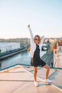 Full length of woman standing against clear sky