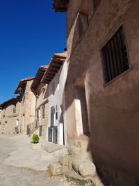 Low angle view of buildings against blue sky