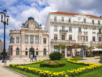 Facade of historic building against cloudy sky