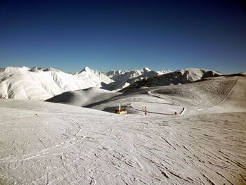 Scenic view of mountains against clear blue sky