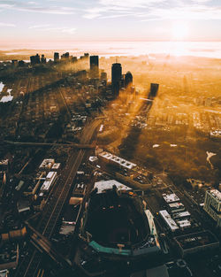 Aerial view of buildings in city against sky