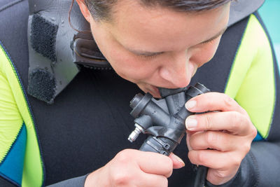 Close-up of woman checking aqualung