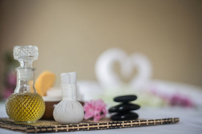 Close-up of spa compress ball and decanter on table