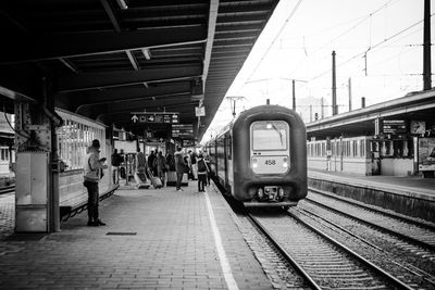 People waiting at railroad station platform