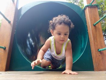Baby girl playing on slide at playground
