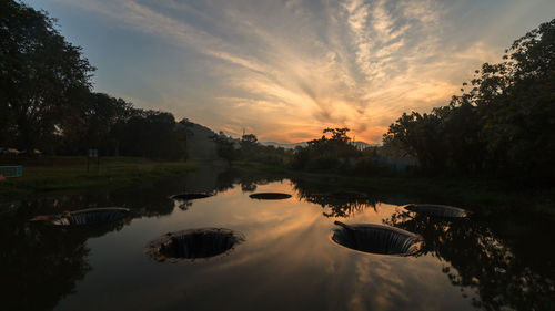 Scenic view of lake against sky during sunset