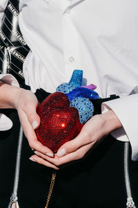 Cropped hand of woman holding gift