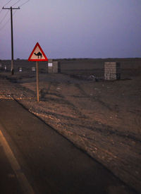 View of road sign against clear sky