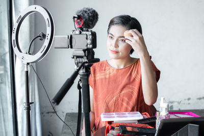 Portrait of young woman using mobile phone