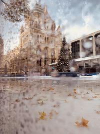Digital composite image of building and trees in puddle