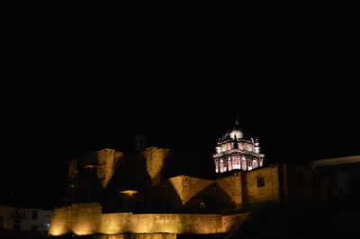 Low angle view of illuminated buildings at night