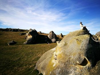 Low angle view of woman sitting on rock at elephant rocks state park