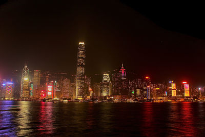 Illuminated skyscrapers in hong kong facing victoria harbour at night