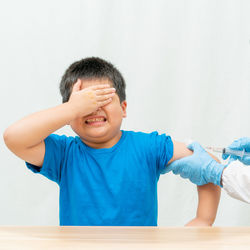 Portrait of boy against wall