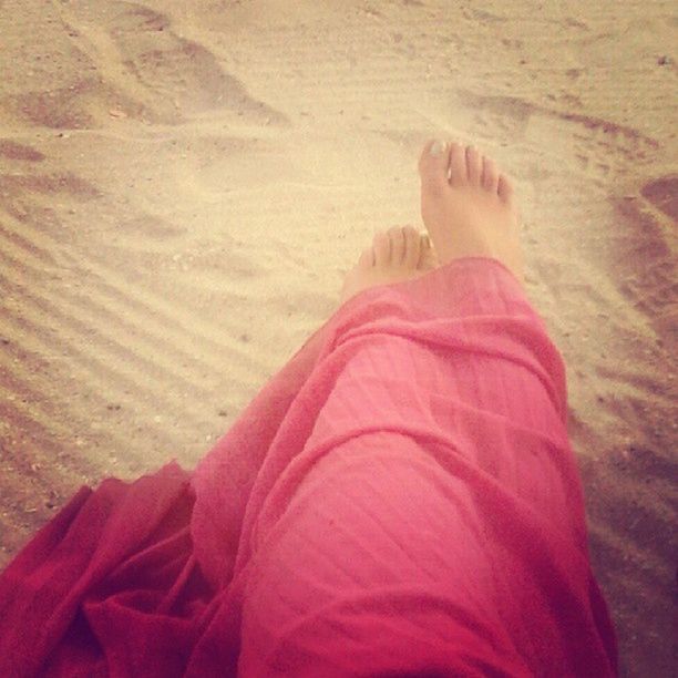 sand, beach, low section, lifestyles, leisure activity, person, barefoot, relaxation, shore, sunlight, red, high angle view, vacations, standing, day, casual clothing, human foot