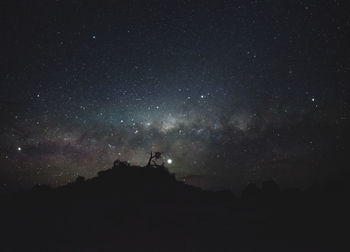 Low angle view of silhouette stars against sky at night