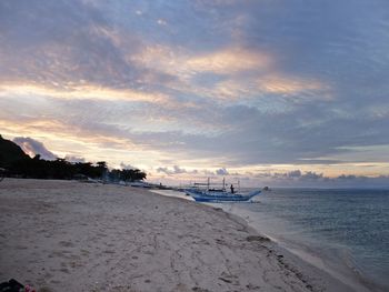 Scenic view of beach against sky during sunset