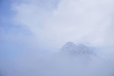 Low angle view of snowcapped mountain against sky