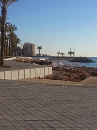 Calm sea against clear blue sky