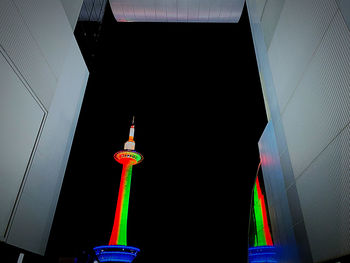 Low angle view of illuminated buildings against sky at night