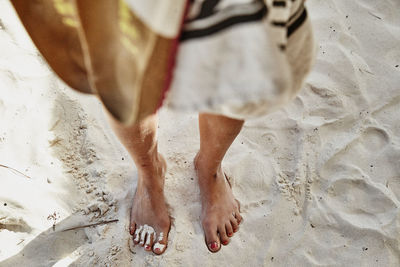 Low section of woman standing on beach