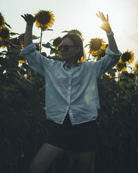 Rear view of woman standing against plants