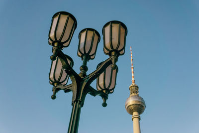 Low angle view of communications tower against building