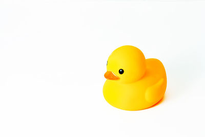 Close-up of yellow toy over white background