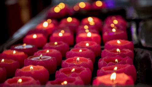 Close-up of lit candles in temple