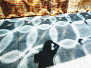 Shadow of person on street in city