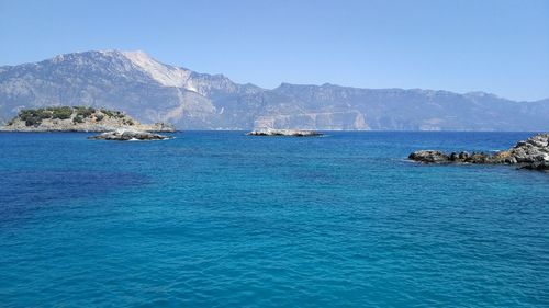 Scenic view of sea against clear blue sky