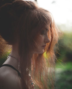Profile view of teenage girl with long brown hair
