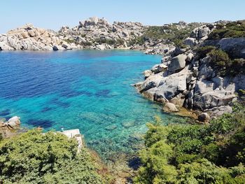 High angle view of sea against clear blue sky