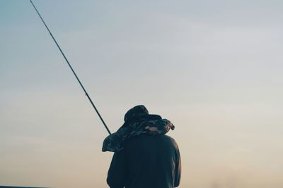 Young woman standing by railing