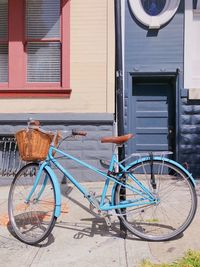 Bicycle parked on street by building