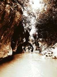 People on rock in cave