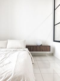 Empty chair against white wall at home