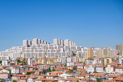 Buildings and residential area against clear blue sky in ankara