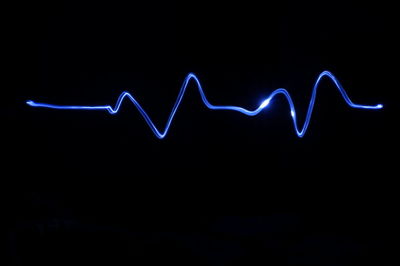 Illuminated pulse trace against black background